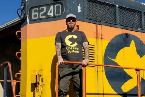 man standing on a platform on a train
