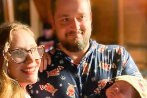 man and woman holding new born